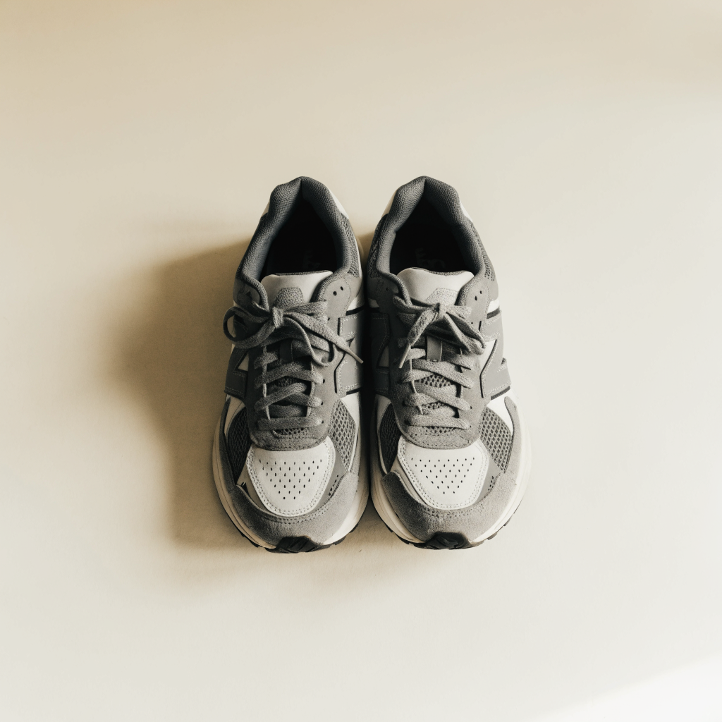 Gray and white running sneakers flat lay